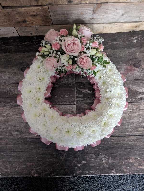 Pink Massed Wreath delivered by The Flower Fountain  1 day ago